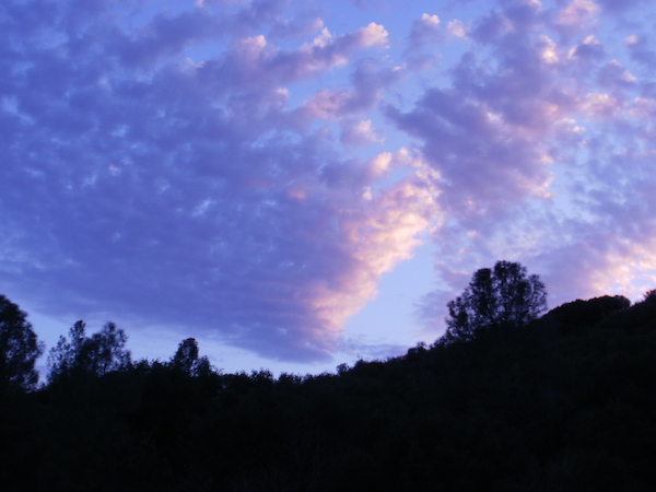 Photograph of - Purple clouds lightened by the early morning sunrise in December.